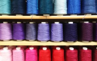 cone yarn in bright colors on shelves