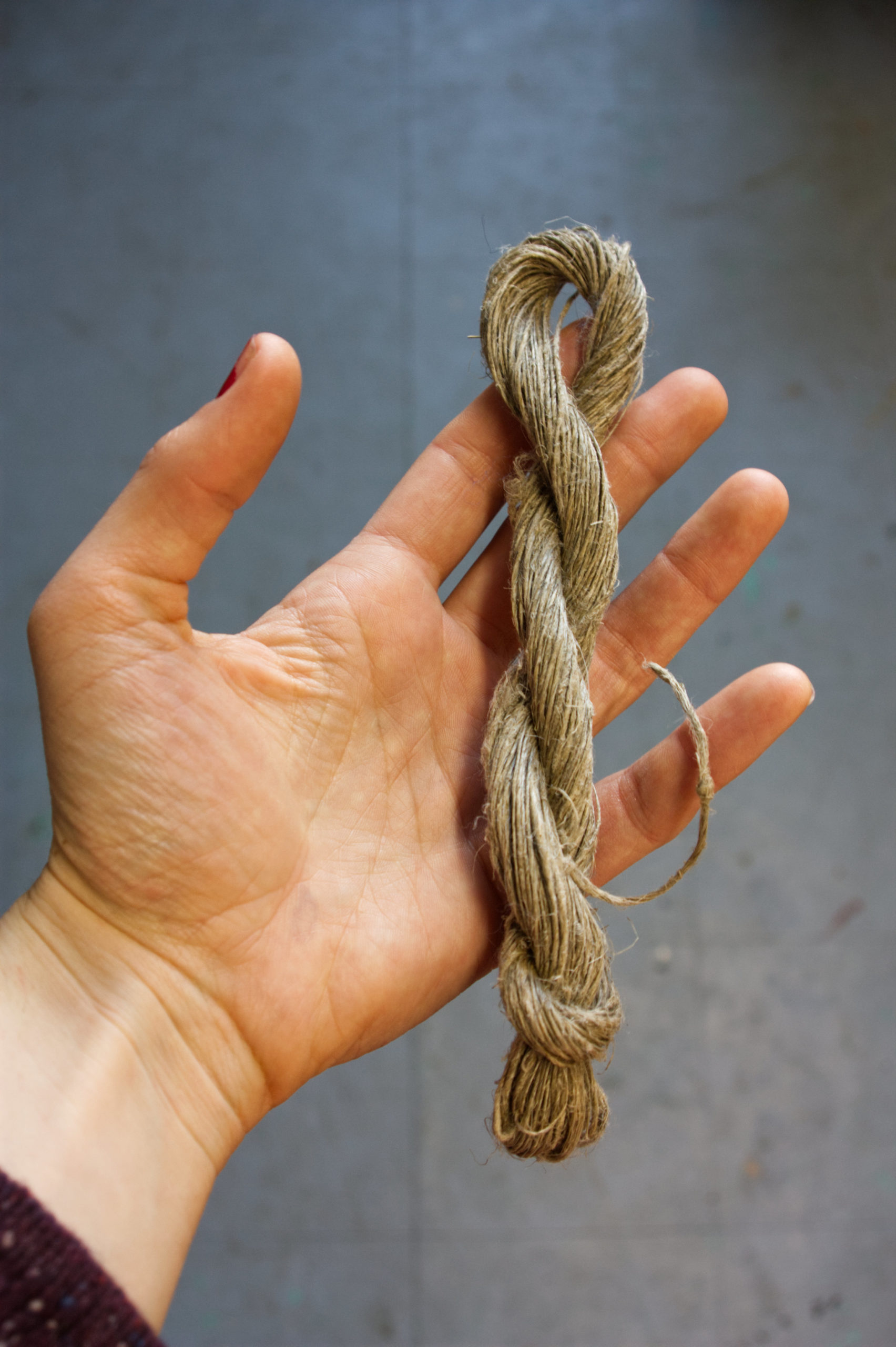 hand with a small skein of linen